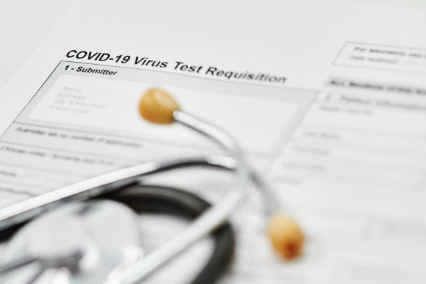 istock COVID-19 Virus test Requisition form with stethoscope on it. Closeup. 1282169840