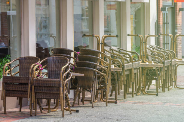 Stacked chairs and tables in front of a closed restaurant in the city center. Restrictions related to the Coronavirus Covid-19.