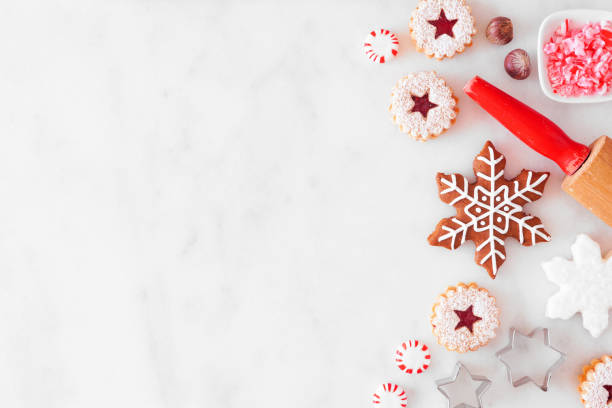 istock Christmas baking side border with cookies and sweets. Overhead view over a white marble background. 1282170390