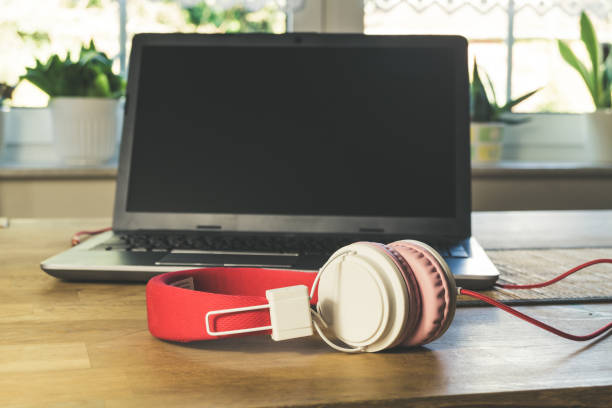 istock Headphones and laptop pc ontable. 1282170419
