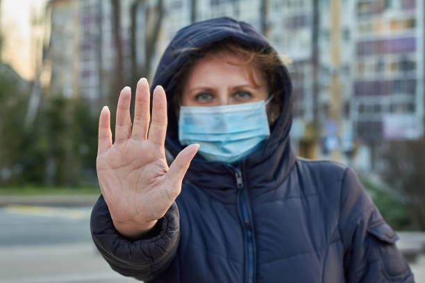 istock Woman wearing face mask during coronavirus outbreak. Virus spread flu prevention carantine. Girl in a facemask on a streets 1282170473