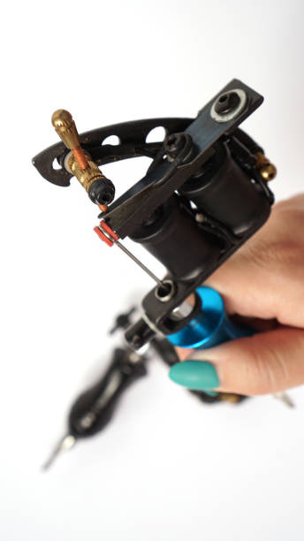 istock Tattoo machine on tattoo artist hand on white background 1282171212