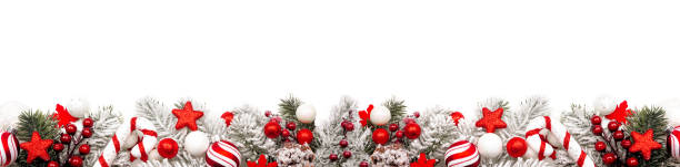 Christmas border of red and white ornaments and frosty branches isolated on white Long Christmas border of red and white ornaments and frosty tree branches isolated on a white background christmas decoration stock pictures, royalty-free photos & images