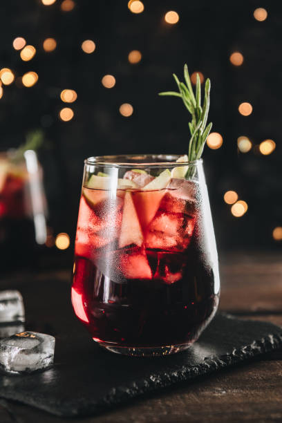 A glass of sangria with ice. Red wine with apples and spices, vertical photo A glass of sangria with ice. Red wine with apples and spices, vertical photo. High quality photo sangria stock pictures, royalty-free photos & images