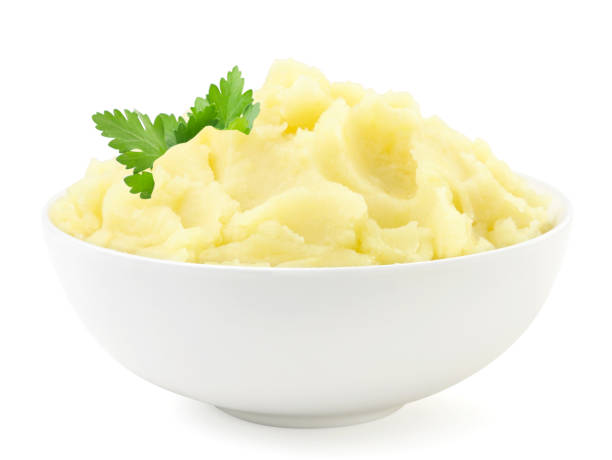 Mashed potatoes with a parsley leaf in a plate on a white background. Isolated Mashed potatoes with a parsley leaf in a plate close-up on a white background. Isolated mashed potatoes stock pictures, royalty-free photos & images