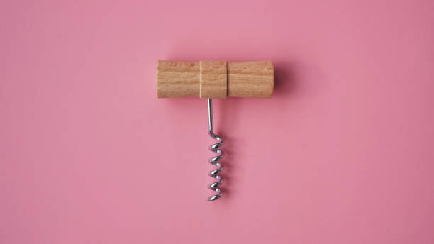 istock Wooden hand corkscrew on pink background 1282172862