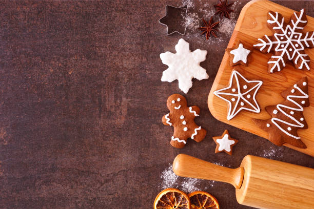 istock Christmas baking side border with gingerbread cookies over a dark stone background 1282172929