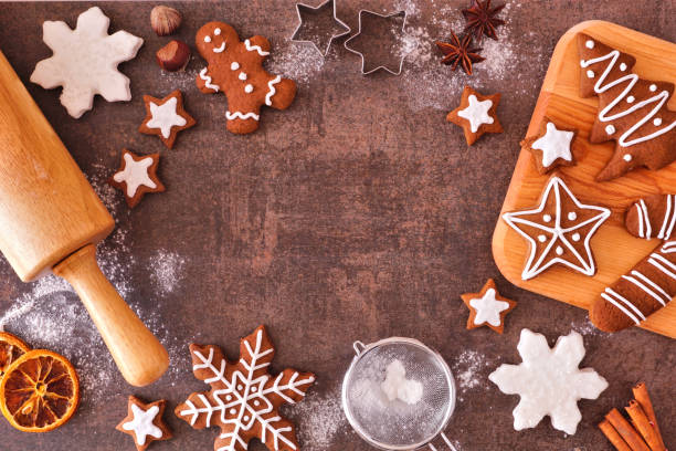 istock Christmas baking frame with gingerbread cookies over a dark stone background 1282172932