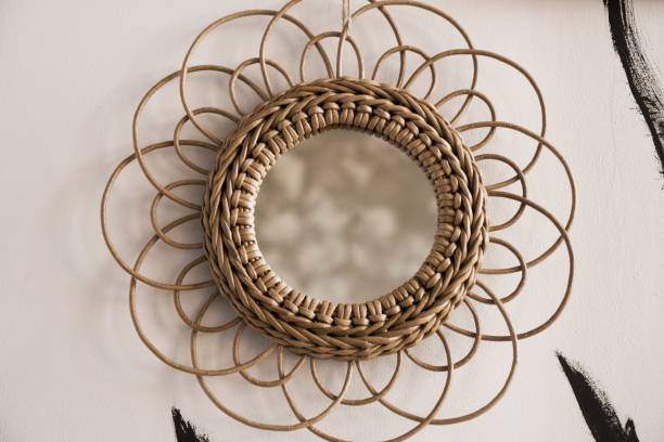 istock Vintage rattan mirrors on white textured wall 1282174993