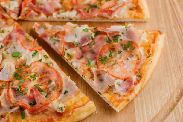 istock Pizza top view cutted on 8 pieces and one pushed forward. Advert for pizzeria caffee and restaurant. Food delivery at quarantine covid-19 concept. 1282175174