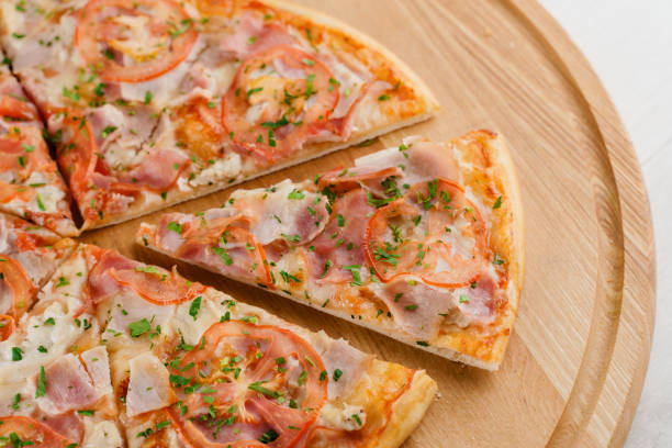 istock Pizza top view cutted on 8 pieces and one pushed forward. Advert for pizzeria caffee and restaurant. Food delivery at quarantine covid-19 concept. 1282175219
