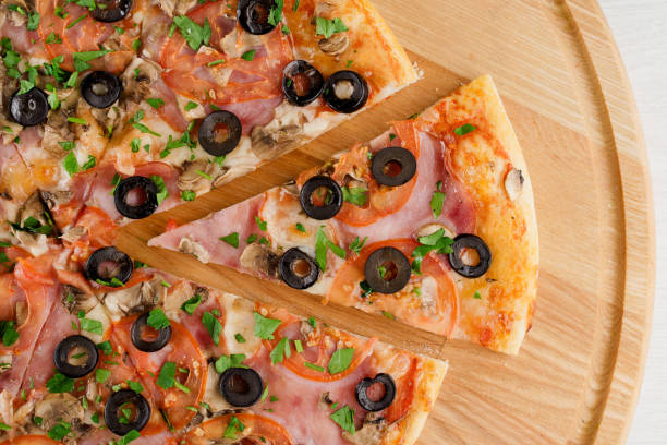 istock Pizza top view cutted on 8 pieces and one pushed forward. Advert for pizzeria caffee and restaurant. Food delivery at quarantine covid-19 concept. 1282175567