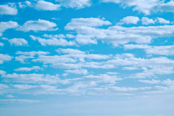 istock Fluffy clouds with vibrant turquoise sky background 1282175937