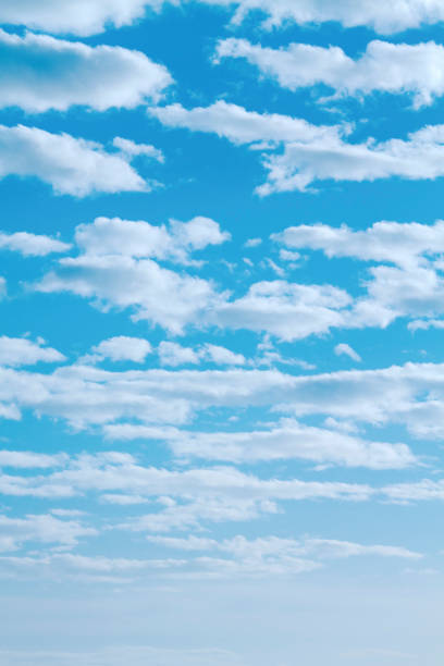 Abstract Light fluffy clouds with vibrant turquoise sky background