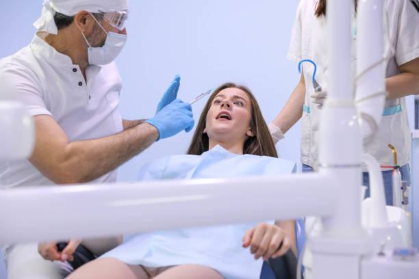 istock Dentist working with patient at light medical background 1282177966