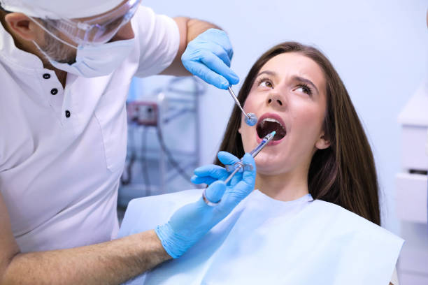 istock Dentist working with patient at light medical background 1282177979