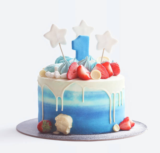 istock Cake for baby's first birthday with number one figure, berries, marshmallows and star shape decoration on white background. 1282181251