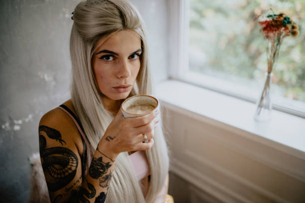 istock Beautiful tattooed woman drinking espresso coffee 1282182603