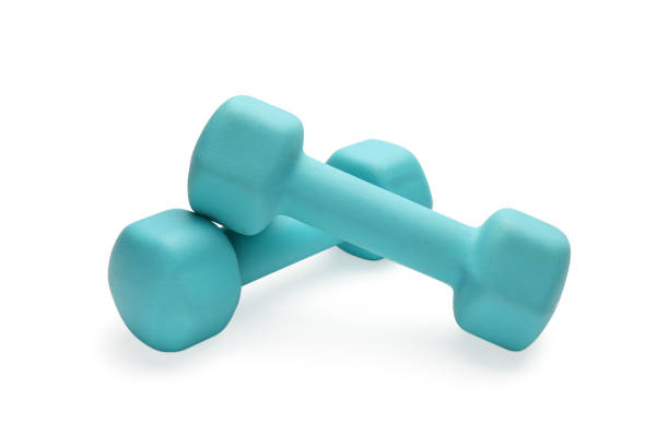 istock Two turquoise colored rubber dumbbells lying at white table 1282184467