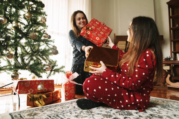 istock Young twin women opening Christmas presents 1282187219