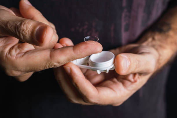 istock Male hand manipulates a contact lens 1282188471