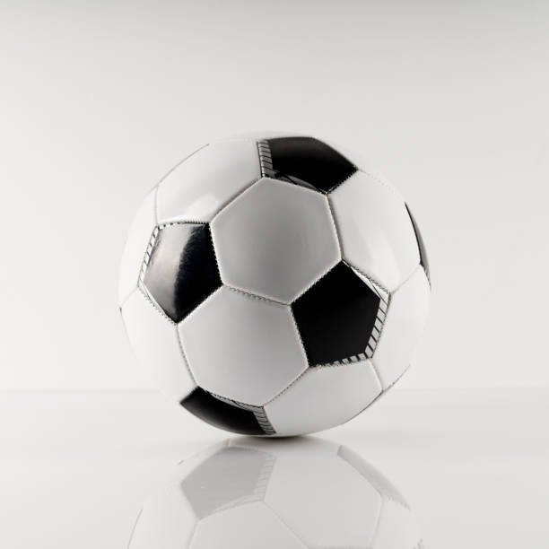 istock Classic soccer ball, typical black and white pattern, isolated on white background. 1282189514