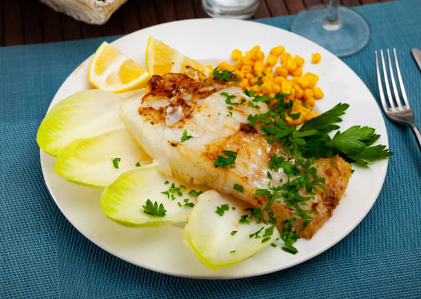 istock Pink cusk-eel fillet with endive, pickled corn, lemon and greens 1282191867