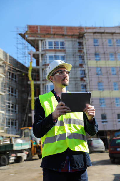 istock Manual worker in blue helmet with digital tablet 1282192464