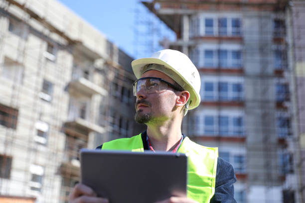 istock Manual worker in blue helmet with digital tablet 1282192499