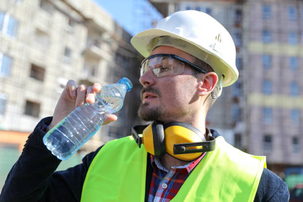 istock boss at construction site with bottle of water, close up 1282192527