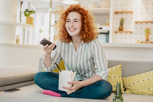 istock Enjoying at home eating takeaway meal and watching tv 1282194590