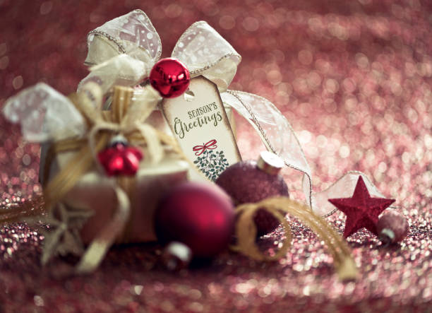 istock Christmas Gift and Red Baubles on a Red Background 1282195454