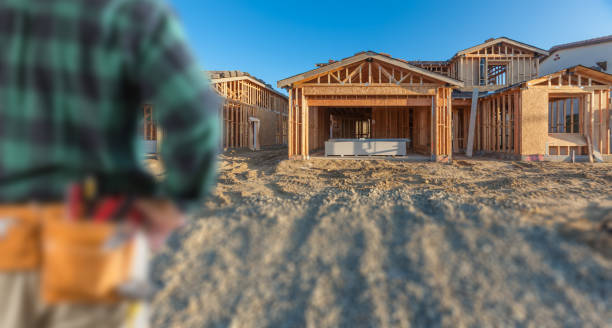 istock Contractor In Front New House Wood Framing at Construction Site 1282195553