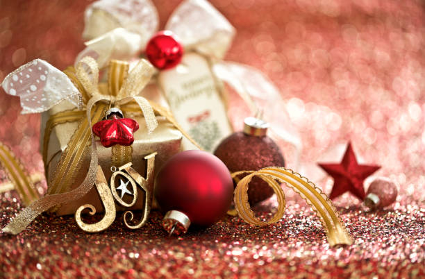 Christmas Gift and Red Baubles on a Red Background