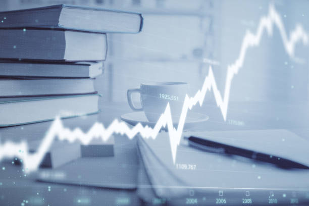 istock Double exposure of financial chart drawing and desktop with coffee and items on table background. Concept of forex market trading 1282202081