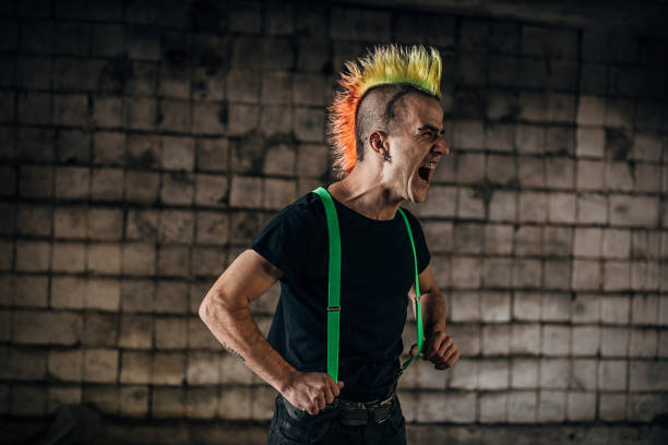 Angry pank man screaming in abandoned warehouse