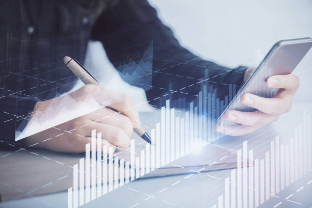 istock Double exposure of forex graph sketch hologram and woman holding and using a mobile device. Stock market concept. 1282202710
