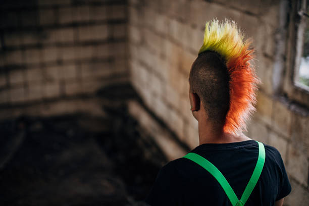 istock Male punk person standing in abandoned building 1282202896