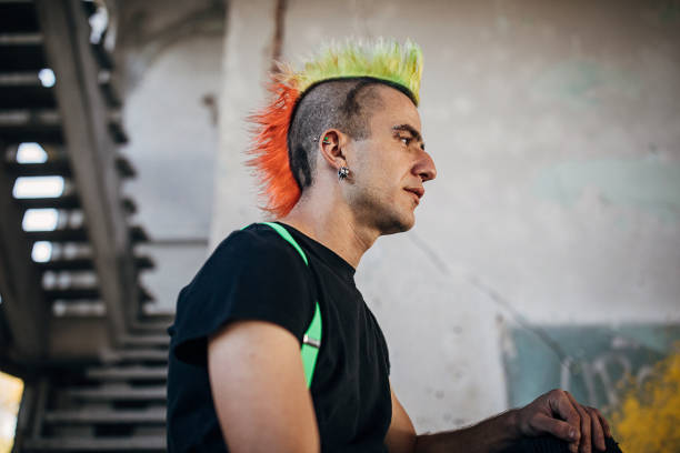 istock Young panker with colorful coiffure sitting in abandoned building 1282204020
