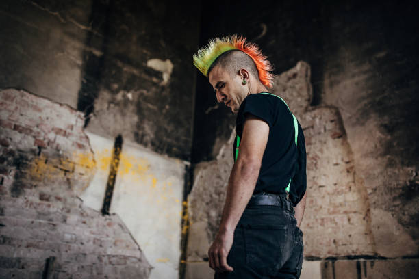 istock One panker with colorful coiffure standing in abandoned warehouse 1282204788