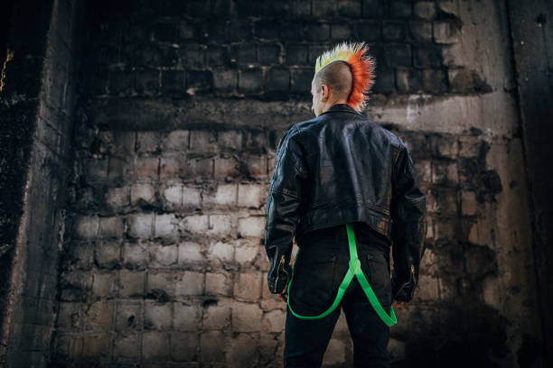 istock Young panker with colorful coiffure standing in abandoned warehouse 1282207337