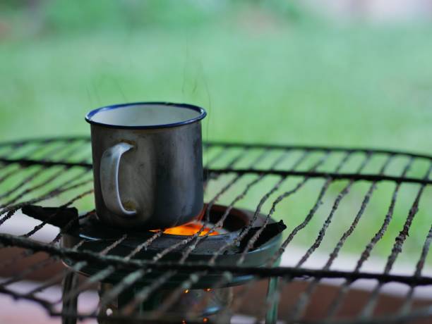 Metal coffee mug over the kerosene camping stove