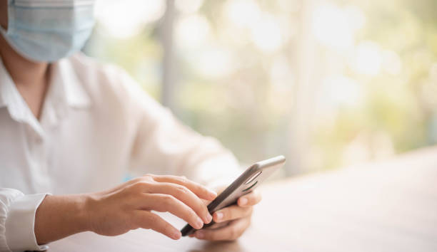 istock Female hand holding smartphone for find something on internet or shopping online while sitting one person for one table in the Co-working space 1282210876