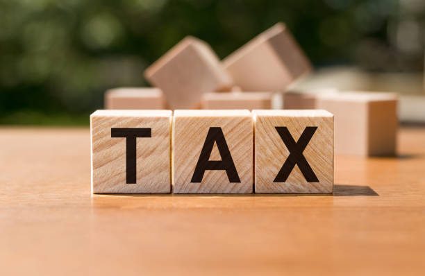 istock Tax concept with wooden blocks on table 1282211672