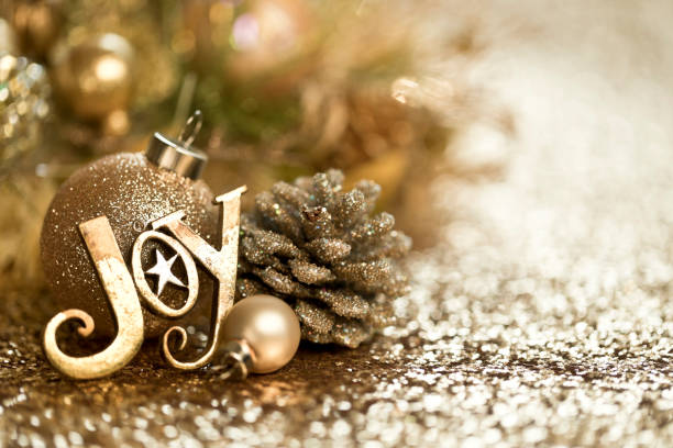 Christmas Gold Ornaments Background Christmas Gold Ornaments Background. Very shallow depth. joy stock pictures, royalty-free photos & images