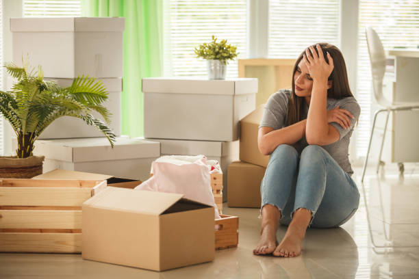istock Copy space of woman sitting among boxes before moving home 1282215228