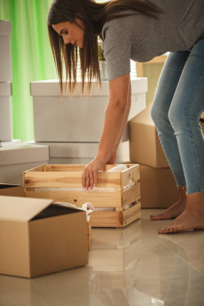 istock Picking up a wooden crate while moving 1282215243
