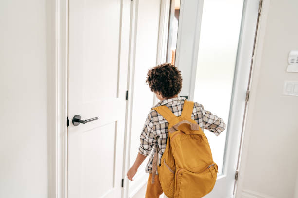 istock Elementary age boy going to school with backpack. he is leaving his house 1282215333