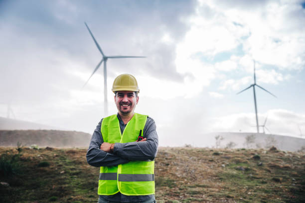 Portrait of young engineer man looking and checking wind turbines