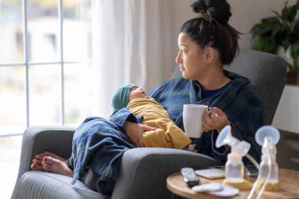 istock Tired new mother holding her baby 1282217910